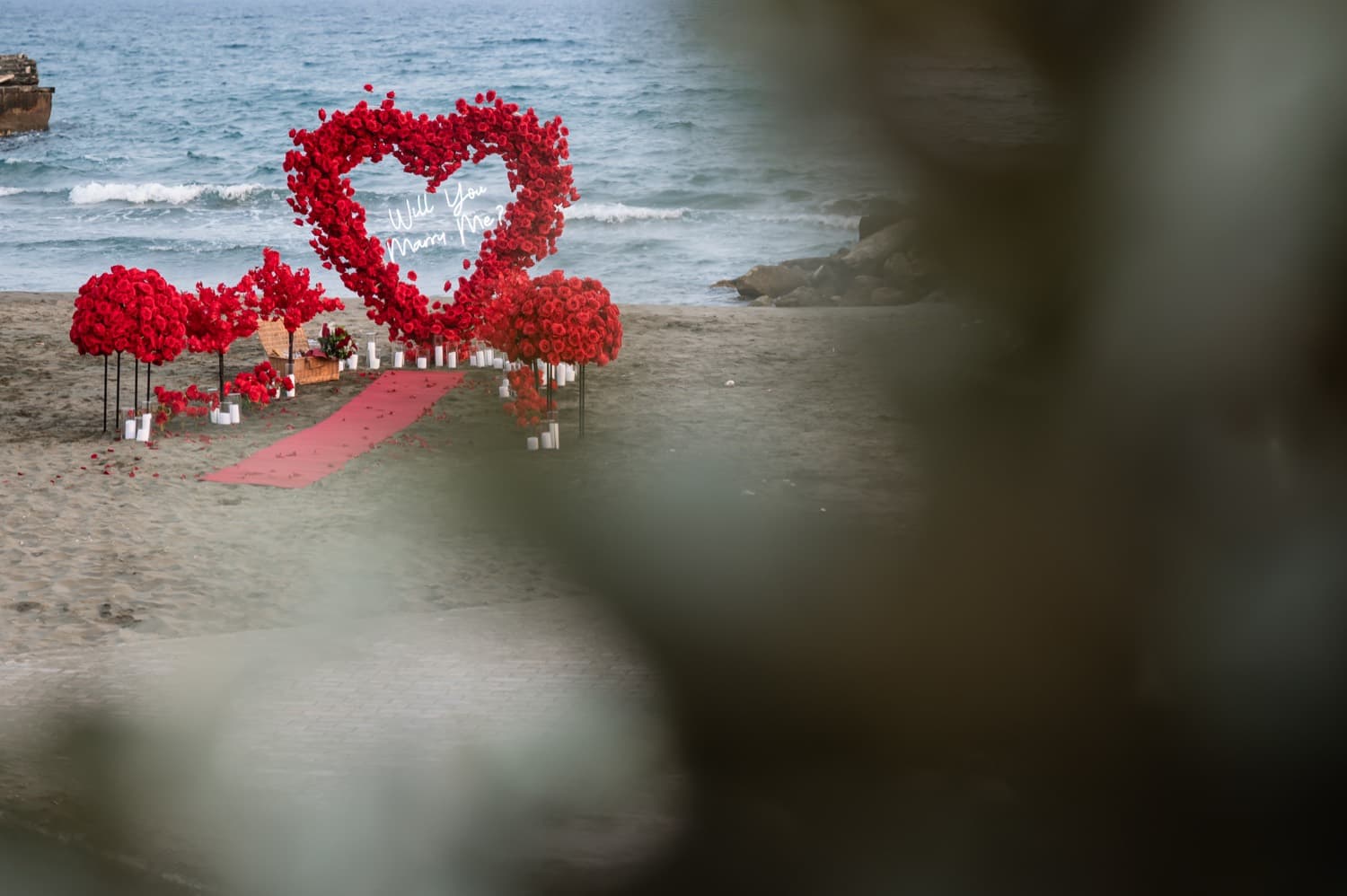 Red rose heart arch proposal on a Cyprus beach