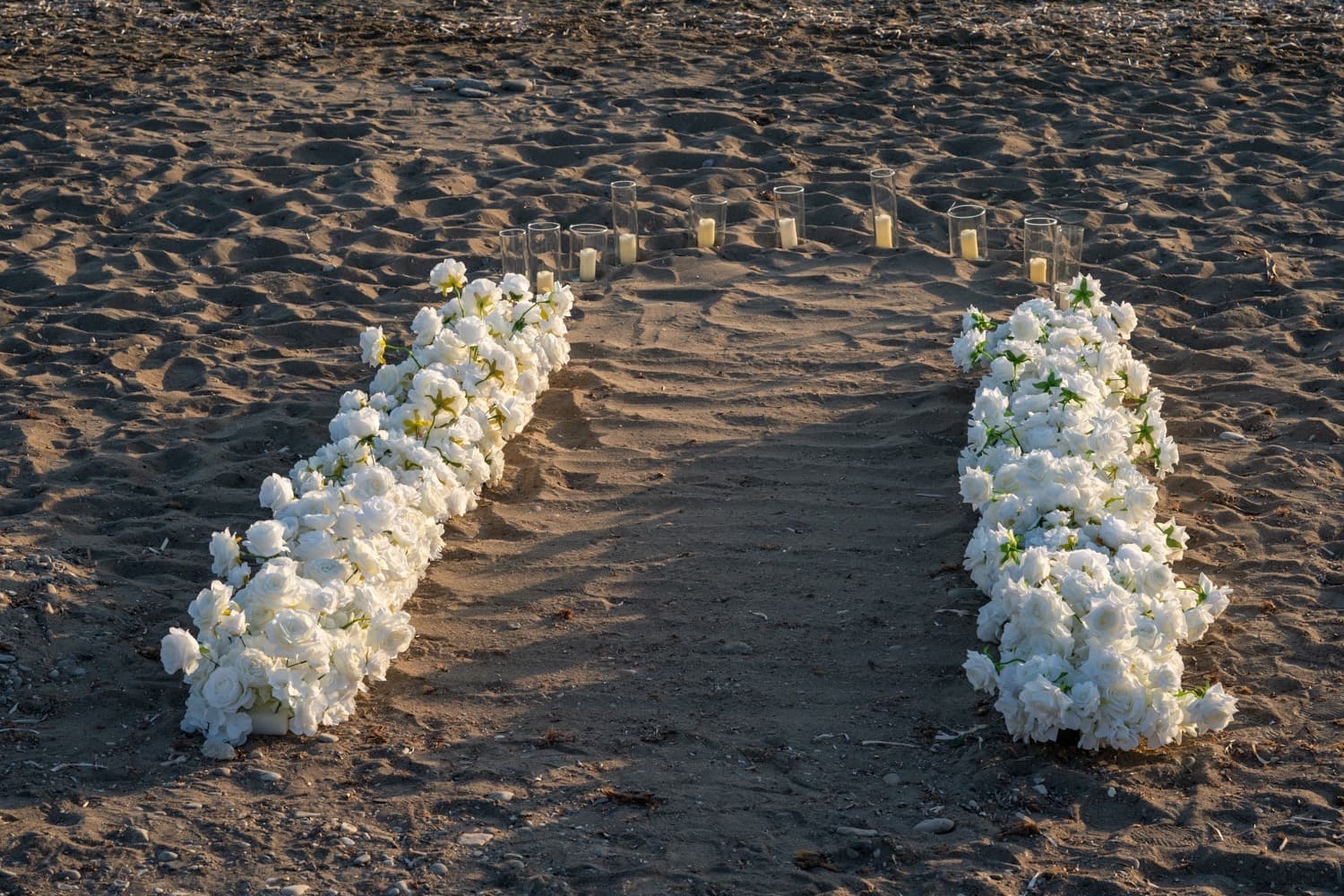 White floral aisle beach proposal in Cyprus