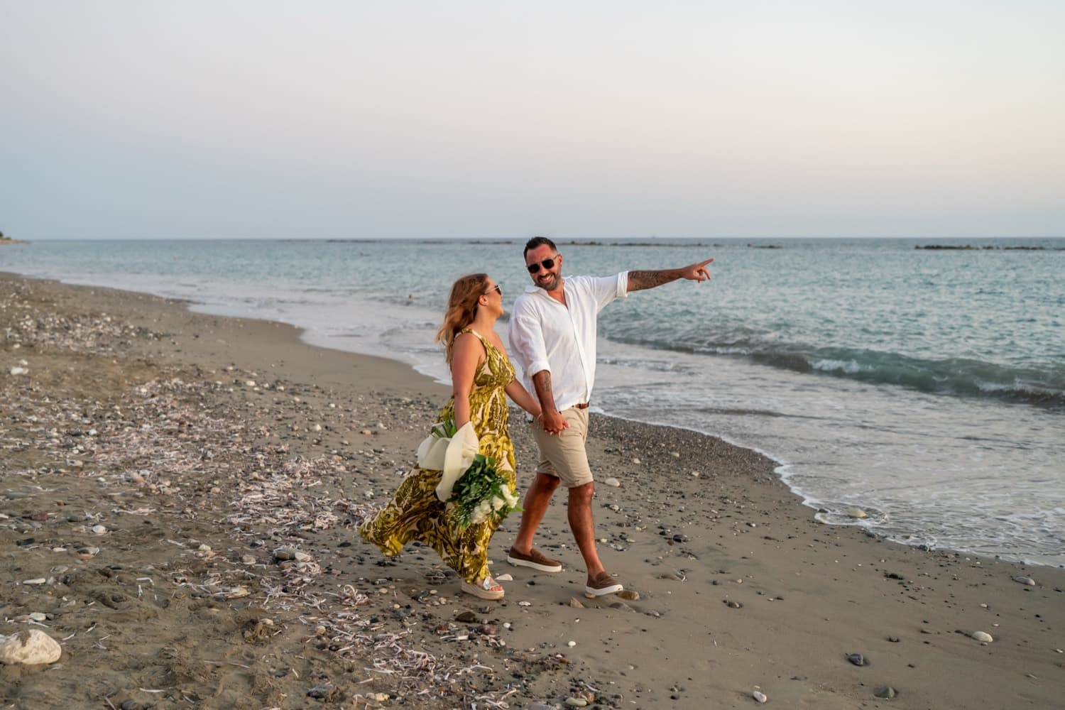 White floral aisle beach proposal in Cyprus